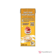 Yellow carton of creamy dessert with a plate of dessert and strawberry toppings on a white background.