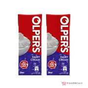 Two boxes of Olper's Dairy Cream on a white background